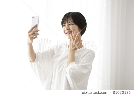 A woman taking a selfie of a ring by the window A woman taking a selfie of a ring by the window 81020185