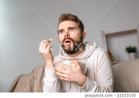 Portrait of guy watching TV series online. Online cinema and video streaming service concept. Portrait of guy watching TV series online. Online cinema and video streaming service concept. 81023330