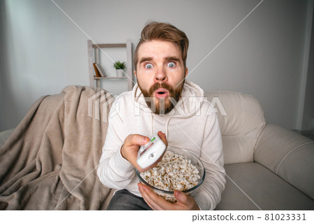 Portrait of guy watching TV series online. Online cinema and video streaming service concept. Portrait of guy watching TV series online. Online cinema and video streaming service concept. 81023331