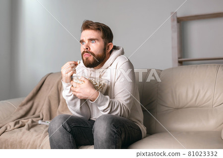 Portrait of guy watching TV series online. Online cinema and video streaming service concept. Portrait of guy watching TV series online. Online cinema and video streaming service concept. 81023332