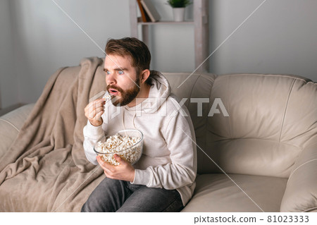 Portrait of guy watching TV series online. Online cinema and video streaming service concept. 81023333
