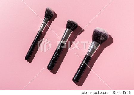 Various make-up brushes on pink background, top view. Cosmetics and beauty concept. Various make-up brushes on pink background, top view. Cosmetics and beauty concept. 81023506