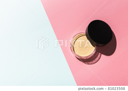 Mineral powder foundation isolated on pink and mint background with copy space. Eco-friendly and organic beauty products Mineral powder foundation isolated on pink and mint background with copy space. Eco-friendly and organic beauty products 81023508