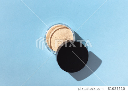 Mineral powder foundation isolated on blue background. Eco-friendly and organic beauty products 81023510