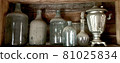 Old dusty glass empty large bottles. 81025834