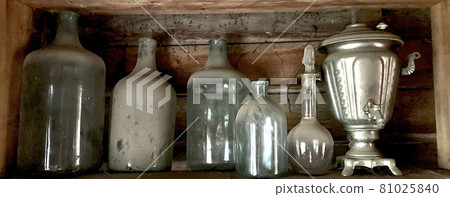 Old dusty glass empty large bottles. 81025840
