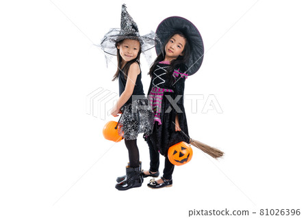 Portrait pair of little girls in Halloween and carnival costume ride the wooden broom isolated on white background 81026396