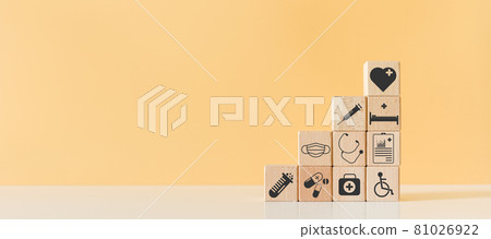 Wooden block with healthcare medical icons orange pastel background. Wooden block with healthcare medical icons orange pastel background. 81026922