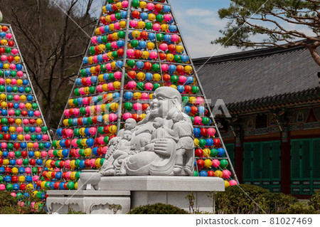 Buddha statue in a buddhist temple Songgwangsa, colorful lantern towers on background, South Korea Buddha statue in a buddhist temple Songgwangsa, colorful lantern towers on background, South Korea 81027469