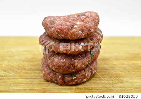 Raw beef meatballs made with various homemade spices, raw beef kofte kofta, on bamboo cutting board Raw beef meatballs made with various homemade spices, raw beef kofte kofta, on bamboo cutting board 81028019