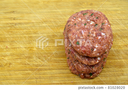 Raw beef meatballs made with various homemade spices, raw beef kofte kofta, on bamboo cutting board Raw beef meatballs made with various homemade spices, raw beef kofte kofta, on bamboo cutting board 81028020