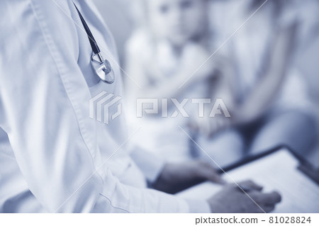 Doctor and patient. Pediatrician using clipboard while examining little girl with her mother at home. Sick and unhappy child at medical exam. Medicine concept Doctor and patient. Pediatrician using clipboard while examining little girl with her mother at home. Sick and unhappy child at medical exam. Medicine concept 81028824