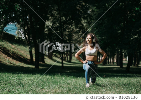 young woman does morning exercises outdoors. photo with a copy s 81029136
