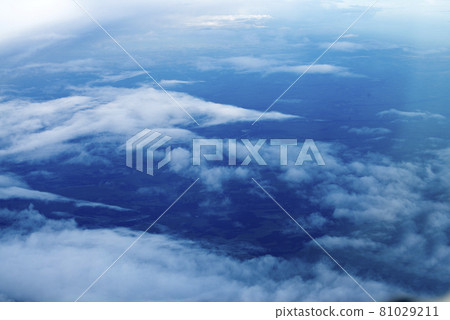 blue sky with white clouds. Puffy clouds horizon. View from the airplane window. DARK BLUE CLOUDS BACKGROUND, NATURE BLUE SKIES. Atmosphere of Earth Sky Blue Daytime, Dark blue background 81029211