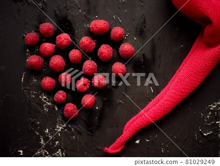 fresh raspberry set with pink napkin on black background. Red heart - Valentine day concept, Love and friendship red colors. tasty fruits and vitamins fresh raspberry set with pink napkin on black background. Red heart - Valentine day concept, Love and friendship red colors. tasty fruits and vitamins 81029249