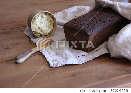 Fresh bread slice and cutting wooden knife on rustic table. homemade bread Fresh bread slice and cutting wooden knife on rustic table. homemade bread 81029319