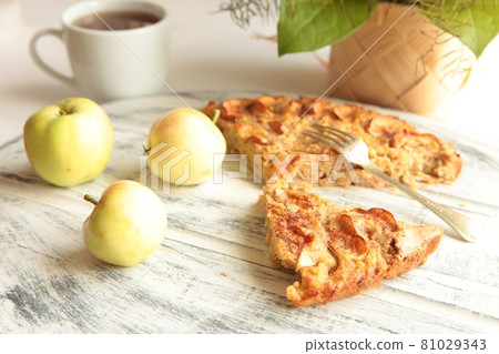 Freshly baked apple pie with apples in the background. Freshly baked apple pie with apples in the background. 81029343