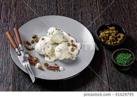 boiled eggs with mayo, anchovy fillets and capers 81029795