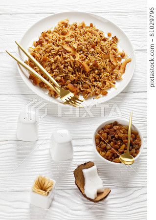 Coconut Rice with raisins on a plate, top view Coconut Rice with raisins on a plate, top view 81029796