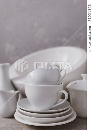 Empty crockery set or white ceramic dishes. White kitchen dishware and tableware on table 81031308