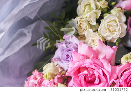 Part of a large bouquet of flowers in close-up. Large pink roses. On a light background, top view. Horizontal composition 81031752