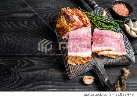 Smoked Sliced Pork loin Meat on a wooden cutting board. Black wooden background. Top view. Copy space 81032479