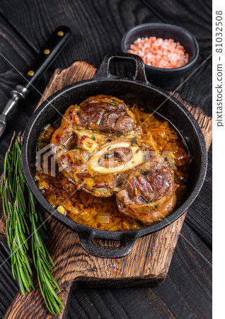 Stew veal shank meat OssoBuco, italian osso buco steak. Black wooden background. Top view Stew veal shank meat OssoBuco, italian osso buco steak. Black wooden background. Top view 81032508
