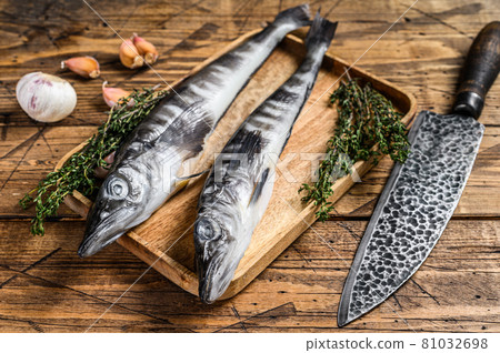 Raw mackerel icefish in a wooden tray. Wooden background. Top view Raw mackerel icefish in a wooden tray. Wooden background. Top view 81032698