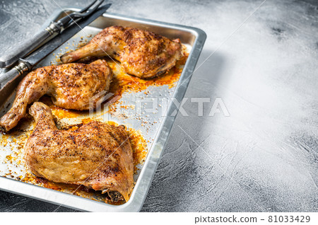 Oven Roasted barbeque chicken legs in baking dish. White background. Top view. Copy space 81033429