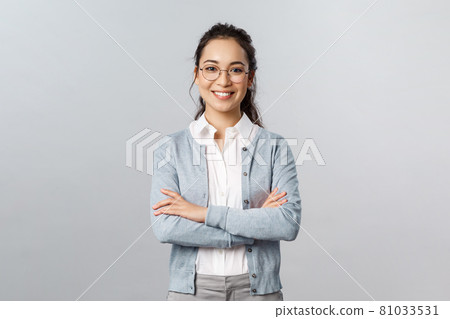 Career, business and education concept. Portrait of cheerful asian girl ready to start online lesson with students, explain class new theme, cross hands chest confident, smiling self-assured Career, business and education concept. Portrait of cheerful asian girl ready to start online lesson with students, explain class new theme, cross hands chest confident, smiling self-assured 81033531