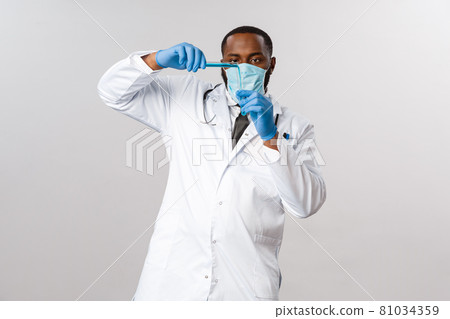 Covid-19, coronavirus patient treatment and laboratory concept. Serious-looking working african-american doctor pour vaccine into test-tube, wear face-mask and latex gloves, prepare anti-flu medicine Covid-19, coronavirus patient treatment and laboratory concept. Serious-looking working african-american doctor pour vaccine into test-tube, wear face-mask and latex gloves, prepare anti-flu medicine 81034359