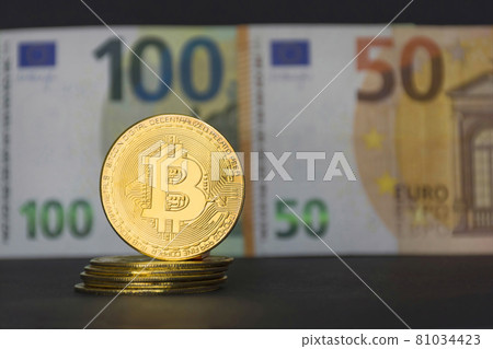 The new virtual money Bitcoin BTC crypto gold coins and Euro currency, selective focus 81034423