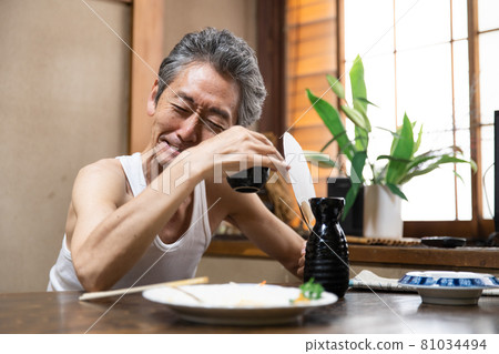 Senior man evening drink alcoholic Senior man evening drink alcoholic 81034494