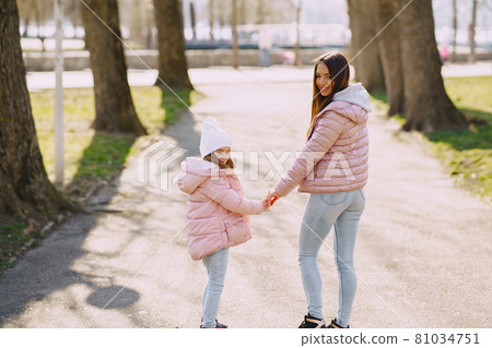 Mother with daughter playing in a spring park 81034751