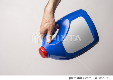 A male hand holging a blue kitchen detergent bottle with closed cap mock-up series A male hand holging a blue kitchen detergent bottle with closed cap mock-up series 81034940