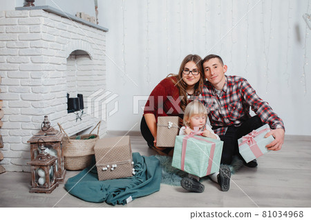 Family sitting at home near fireplase Family sitting at home near fireplase 81034968