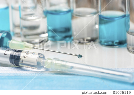 Coronavirus vaccine: covid-19 bottle vaccination. Coronavirus vaccine: covid-19 vaccine bottle vaccination and syringe to inject the vaccine 81036119