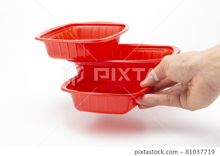 A plastic box in hand for holding food on a white background A plastic box in hand for holding food on a white background 81037719