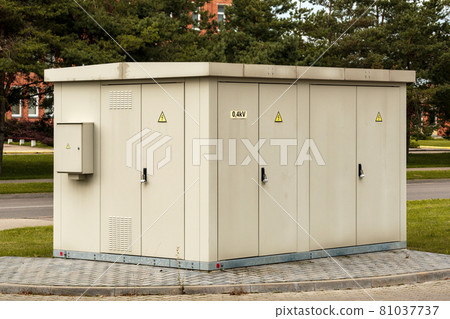 Light gray transformer box on the side of pavement Light gray transformer box on the side of pavement 81037737