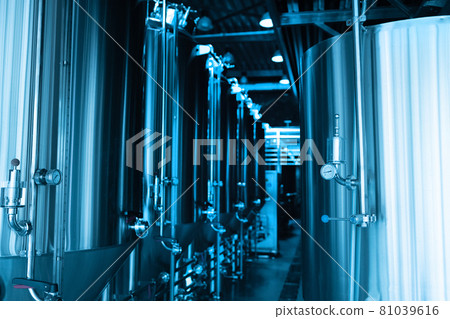 Industrial interior of modern craft brewery with chrome cylindrical metal beer tanks. Private microbrewery. Industrial interior of modern craft brewery with chrome cylindrical metal beer tanks. Private microbrewery. 81039616