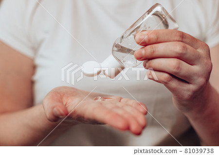 Caucasian woman using antibacterial antiseptic gel to clean her hands, hygiene concept to protect against flu virus outbreak. Hands disinfection. Caucasian woman using antibacterial antiseptic gel to clean her hands, hygiene concept to protect against flu virus outbreak. Hands disinfection. 81039738