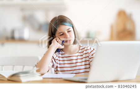 Girl doing homework or online education. 81040245