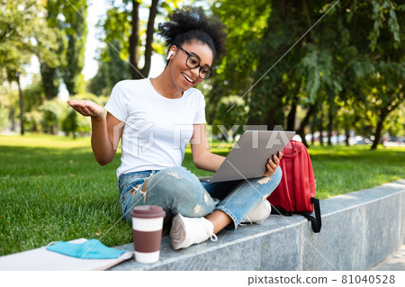 American American Student Girl Using Laptop Making Video Call Outside American American Student Girl Using Laptop Making Video Call Outside 81040528