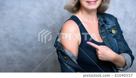 Woman showing arm with plaster after getting COVID-19 vaccine Woman showing arm with plaster after getting COVID-19 vaccine 81040557