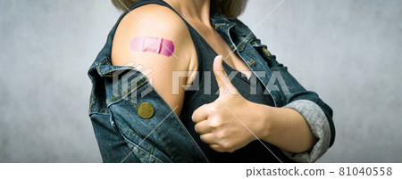 Woman showing shoulder with plaster after getting COVID-19 vaccine Woman showing shoulder with plaster after getting COVID-19 vaccine 81040558