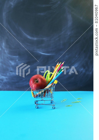 Toy trolley with stationery and apple on the background of the school board, the concept of back to school, sales of materials for study, gifts, education holidays Toy trolley with stationery and apple on the background of the school board, the concept of back to school, sales of materials for study, gifts, education holidays 81040967