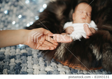 close-up. mother caresses a sleeping newborn baby. close-up. mother caresses a sleeping newborn baby. 81043131