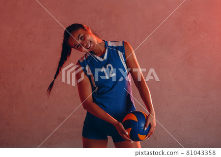 Young woman smiling volleyball player with ball 81043358