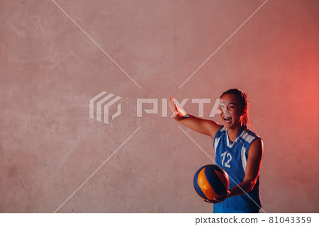 Young woman smiling volleyball player with ball 81043359