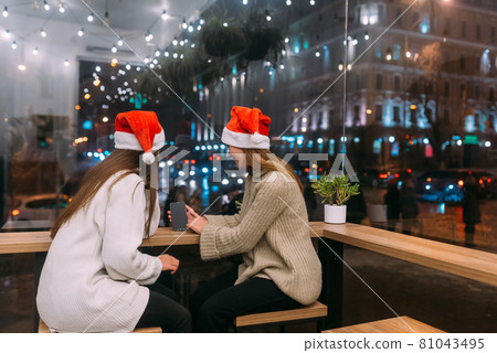 Two young girls using smartphone at the cafe. Two young girls using smartphone at the cafe. 81043495